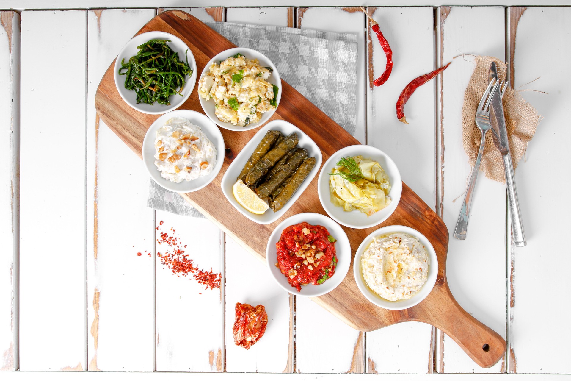 Collection of tapas foods including dates, yogurt, sarma, fresh mozzarella